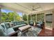 Inviting screened porch with comfortable seating and a ceiling fan at 706 Evans Manor Dr, Weddington, NC 28104