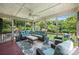 Relaxing screened-in porch with comfortable outdoor seating and wooded views at 706 Evans Manor Dr, Weddington, NC 28104