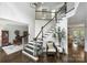 Elegant entry with hardwood floors, staircase and view into dining and living areas at 706 Evans Manor Dr, Weddington, NC 28104