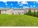 Large backyard with expansive lawn, mature trees, and an outdoor patio, ideal for relaxation and entertaining at 7316 Hamilton Bridge Rd, Charlotte, NC 28278