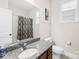 Well-lit bathroom with granite countertop, large mirror, and shower with patterned curtain at 7316 Hamilton Bridge Rd, Charlotte, NC 28278