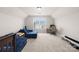 Spacious bonus room featuring a comfortable couch and functional desk area with a window view at 7316 Hamilton Bridge Rd, Charlotte, NC 28278