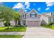 Inviting two-story home boasts a well-kept lawn, two-car garage, and a charming facade on a sunny day at 7316 Hamilton Bridge Rd, Charlotte, NC 28278