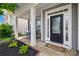 Charming front porch with decorative door and welcome mat, complemented by well-kept landscaping and manicured lawn at 7316 Hamilton Bridge Rd, Charlotte, NC 28278