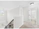Bright hallway with staircase, white trim, and a view of the front door at 7316 Hamilton Bridge Rd, Charlotte, NC 28278