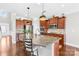 This kitchen features wood cabinets, granite counters, stainless appliances, and an eat-in kitchen island at 7316 Hamilton Bridge Rd, Charlotte, NC 28278