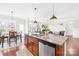 Open concept kitchen with eat-in island and breakfast nook leading to living area with fireplace at 7316 Hamilton Bridge Rd, Charlotte, NC 28278
