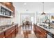 A modern kitchen with gas stove, wood cabinets, granite countertops, and an eat-in nook at 7316 Hamilton Bridge Rd, Charlotte, NC 28278