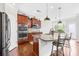 Modern kitchen featuring granite countertops, a stainless-steel refrigerator, and an island with barstool seating at 7316 Hamilton Bridge Rd, Charlotte, NC 28278