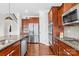 This kitchen has stainless appliances, wood cabinets, granite counters, and an attached eat-in kitchen at 7316 Hamilton Bridge Rd, Charlotte, NC 28278