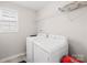 Bright laundry room with a front load washer, dryer, a window and shelving at 7316 Hamilton Bridge Rd, Charlotte, NC 28278