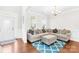 Cozy living room with hardwood floors, natural light, and a comfortable L-shaped sectional sofa at 7316 Hamilton Bridge Rd at 7316 Hamilton Bridge Rd, Charlotte, NC 28278