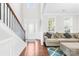 Inviting living room featuring hardwood floors, a staircase, and comfortable seating area at 7316 Hamilton Bridge Rd at 7316 Hamilton Bridge Rd, Charlotte, NC 28278