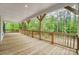 A large wooden deck with a railing overlooking a private wooded backyard at 762 Highway 274 Hwy, Clover, SC 29710