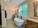 Stylish bathroom with soaker tub, double sink vanity, and natural light from large window at 762 Highway 274 Hwy, Clover, SC 29710