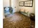 Unique bathroom showcasing brick floors, a tiled shower, and a vintage-inspired bench with pillows at 762 Highway 274 Hwy, Clover, SC 29710