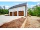 Three-car garage with wood doors and a large driveway, set on a well-manicured lot at 762 Highway 274 Hwy, Clover, SC 29710