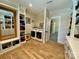 Spacious laundry room and walk-in closet with shelving and natural light, wood floors, and white cabinets at 762 Highway 274 Hwy, Clover, SC 29710