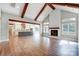 Spacious living room with hardwood floors, vaulted ceiling, and fireplace, flowing into a modern kitchen at 762 Highway 274 Hwy, Clover, SC 29710