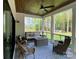 Inviting covered porch with a wood ceiling, ceiling fan, and comfortable seating with a wooded view at 762 Highway 274 Hwy, Clover, SC 29710