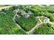Aerial view of houses nestled among lush green trees in a beautiful neighborhood setting at 7768 Pinecone Ln, Hickory, NC 28602