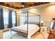Spacious bedroom featuring a striking canopy bed, decorative ceiling, and plush carpet at 7768 Pinecone Ln, Hickory, NC 28602