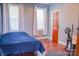 Cozy bedroom with a blue quilted bedspread, natural light, and beautiful wood floors for a serene retreat at 7768 Pinecone Ln, Hickory, NC 28602