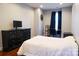 Cozy bedroom features a comfortable bed, a dark dresser, and a sunburst wall decoration at 7768 Pinecone Ln, Hickory, NC 28602