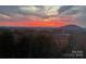 Scenic mountain view at sunset showcasing a fiery sky, and distant hills at 7768 Pinecone Ln, Hickory, NC 28602