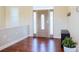 Bright entryway features wood floors, paneled front door, and natural light at 7768 Pinecone Ln, Hickory, NC 28602