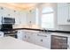 Stylish kitchen featuring white cabinetry, stainless steel appliances, and quartz countertops with ample counter space at 7768 Pinecone Ln, Hickory, NC 28602
