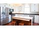 Modern kitchen showcases stainless steel appliances, white cabinetry, and an island with wooden stools for casual dining at 7768 Pinecone Ln, Hickory, NC 28602