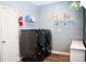 Convenient laundry room featuring a modern washer and dryer set and ample shelving for storage at 7768 Pinecone Ln, Hickory, NC 28602