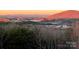 Expansive mountain view lot with sunrise, showing wooded area leading to a valley and mountain range with a colorful sky at 7768 Pinecone Ln, Hickory, NC 28602