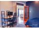 Home office space with a modern desk setup, wood floors, and a comfortable workspace overlooking the bedroom at 7768 Pinecone Ln, Hickory, NC 28602