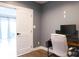 Bright home office space with modern gray walls, luxury vinyl plank and a desk with computer at 7768 Pinecone Ln, Hickory, NC 28602