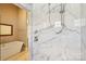 This bathroom features a glass shower stall with marble-look tile at 7908 Rea View Ct, Charlotte, NC 28226