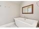 Relax in this bathroom featuring a freestanding tub and marble floors at 7908 Rea View Ct, Charlotte, NC 28226