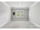 Neutral bedroom with carpeted floor and ample light from large window at 7908 Rea View Ct, Charlotte, NC 28226