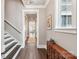 Charming entryway featuring hardwood floors, stairway, trim details, a window, and decorative furnishings at 7908 Rea View Ct, Charlotte, NC 28226