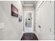 Hallway with hardwood floors, artwork, and views into a bedroom at 7908 Rea View Ct, Charlotte, NC 28226
