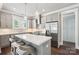 Modern kitchen features gray cabinets, marble backsplash, stainless steel appliances, and a large quartz island at 7908 Rea View Ct, Charlotte, NC 28226