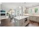 Open-concept kitchen with stainless steel appliances, island with seating, and seamless flow into the living area at 7908 Rea View Ct, Charlotte, NC 28226