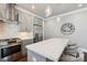 Contemporary kitchen with a quartz countertop island, stainless steel appliances, and overhead lighting at 7908 Rea View Ct, Charlotte, NC 28226