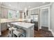 Modern kitchen featuring an island with barstool seating, stainless steel appliances, and stylish pendant lighting at 7908 Rea View Ct, Charlotte, NC 28226