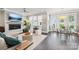 Cozy living room with a fireplace, TV, many windows, a comfortable sectional, and an adjacent dining area at 7908 Rea View Ct, Charlotte, NC 28226