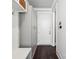 A stylish mudroom with gray storage cabinets, white bench, hooks, and dark hardwood floors at 7908 Rea View Ct, Charlotte, NC 28226