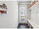 Mudroom with a white bench, storage baskets, hooks, and a view of the outdoors at 7908 Rea View Ct, Charlotte, NC 28226