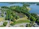 Beautiful aerial view of community with a pond, fountain, walking path, and mature trees near the lake at 815 Jetton St, Davidson, NC 28036