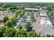 An aerial view showing nearby shopping and dining with plenty of parking and mature trees at 815 Jetton St, Davidson, NC 28036